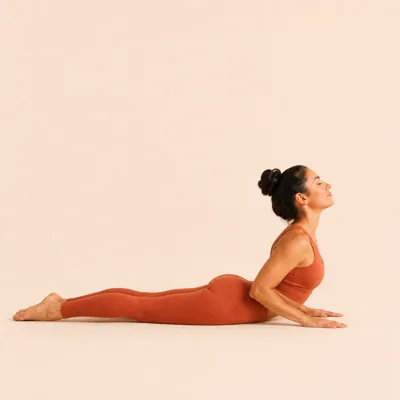 Cobra: chest sliding forward and up in a low lift, elbows bent and hips grounded.