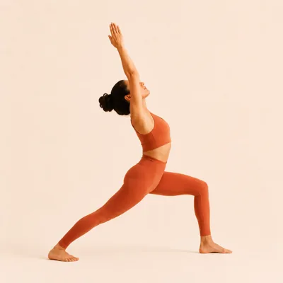 Warrior 1 with the left leg forward: front knee bent over the ankle, arms reaching overhead.